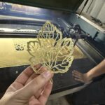 intricate golden acrylic leaf mirror